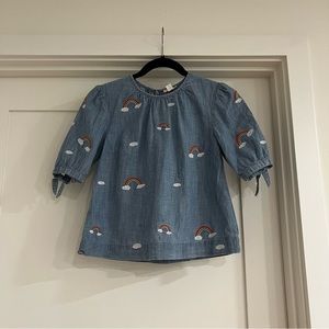 Girls crewcuts blue top with small rainbows and clouds.